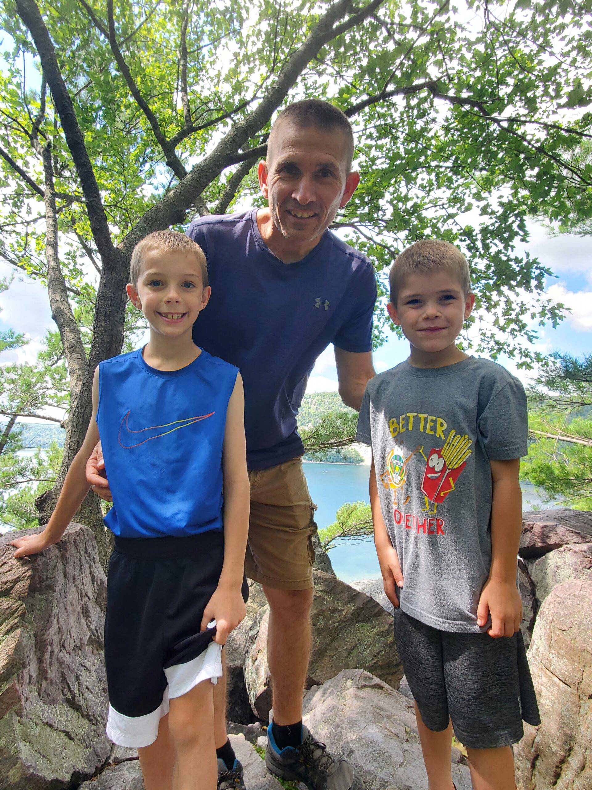 Sean Brown, co-owner of a U-pick fruit and nut farm, with sons Ty and Everett