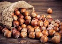 Chestnuts spilling from a burlap sack onto a rustic wooden table