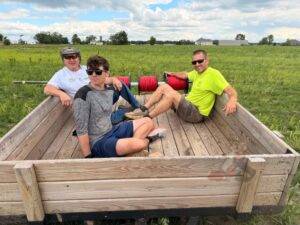 Members of the irrigation installation crew riding back across the farm to retrieve additional supplies and materials.