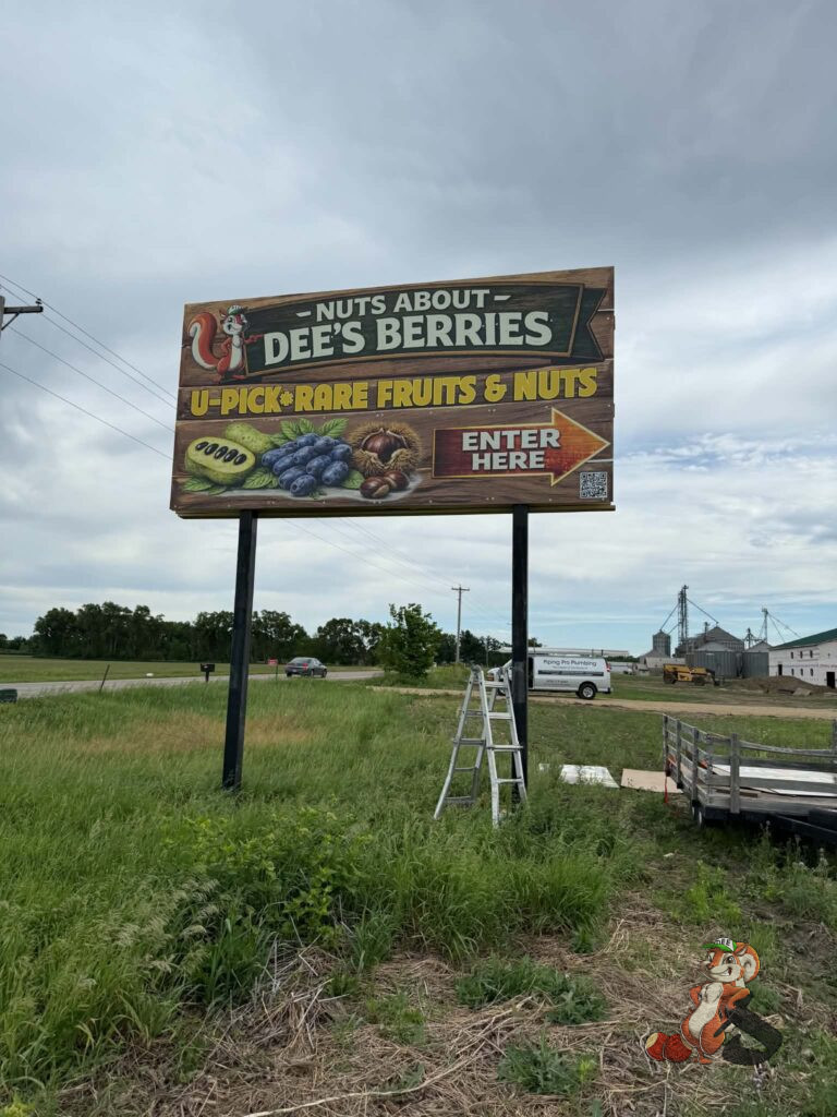 Nuts About Dee's Berries billboard sign along Highway 104 in Brodhead Wisconsin promoting U-pick rare fruits and nuts including pawpaw, chestnuts, and berries.